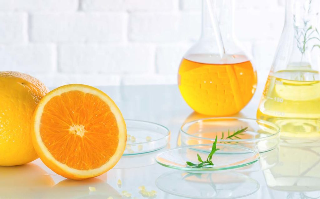 Photo showing oranges and vitamin C serum